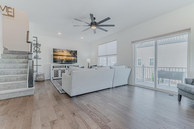 living room featuring ceiling fan and hardwood / wood-style floors