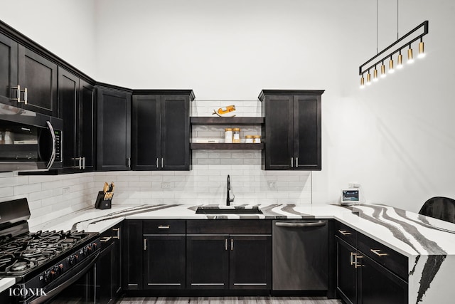 kitchen with decorative backsplash, sink, stainless steel appliances, and light stone counters