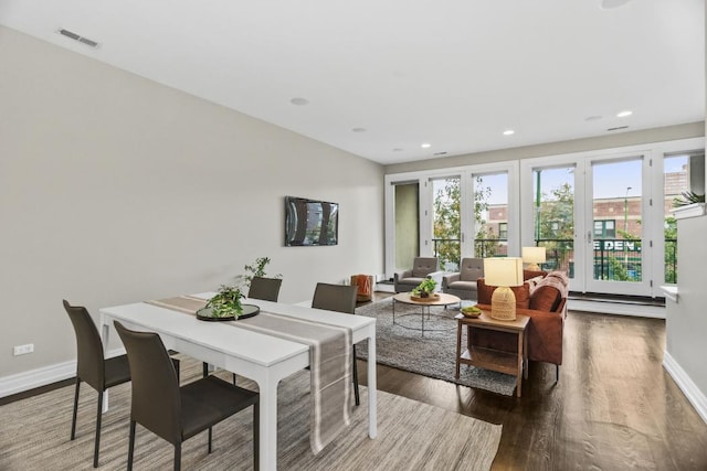 dining space with dark wood-type flooring