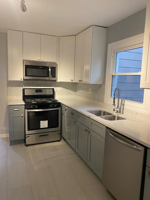 kitchen with white cabinets, sink, and appliances with stainless steel finishes