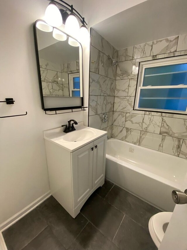 full bathroom with tile patterned floors, tiled shower / bath combo, toilet, and vanity