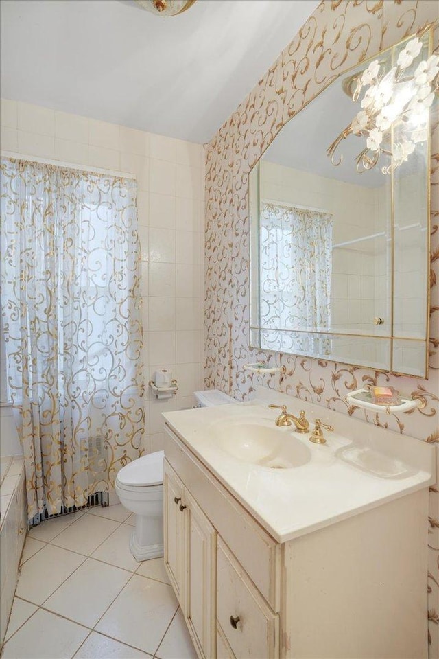 full bathroom with tile patterned floors, vanity, toilet, and shower / bath combo with shower curtain