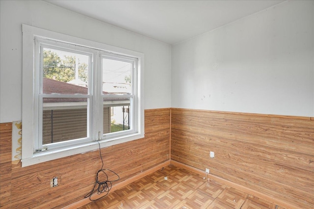 empty room featuring light parquet floors and a healthy amount of sunlight