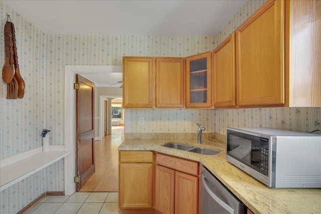 kitchen featuring light tile patterned floors, stainless steel appliances, and sink