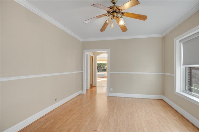 unfurnished room with ceiling fan, light hardwood / wood-style flooring, and ornamental molding