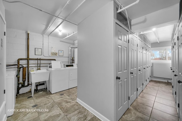 laundry area featuring washer and clothes dryer and sink