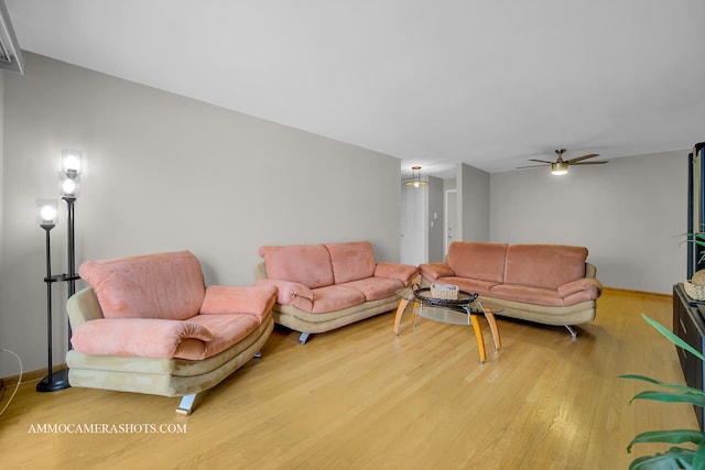 living room featuring hardwood / wood-style floors and ceiling fan