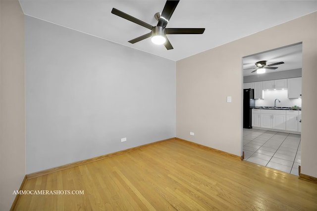 spare room featuring light wood-type flooring and sink