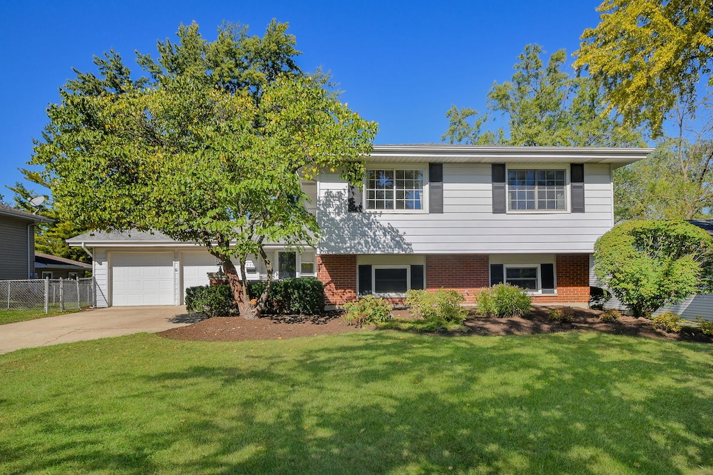 view of front of home with a front yard and a garage