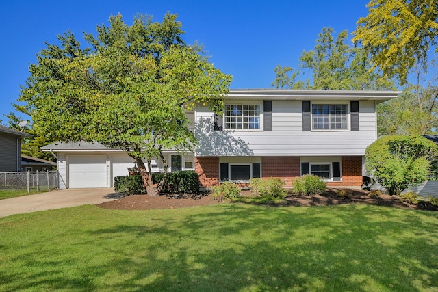 view of front of home with a front yard and a garage