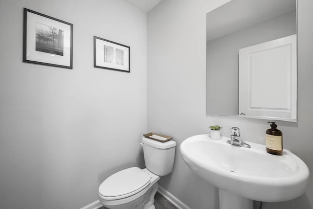 bathroom featuring toilet and sink