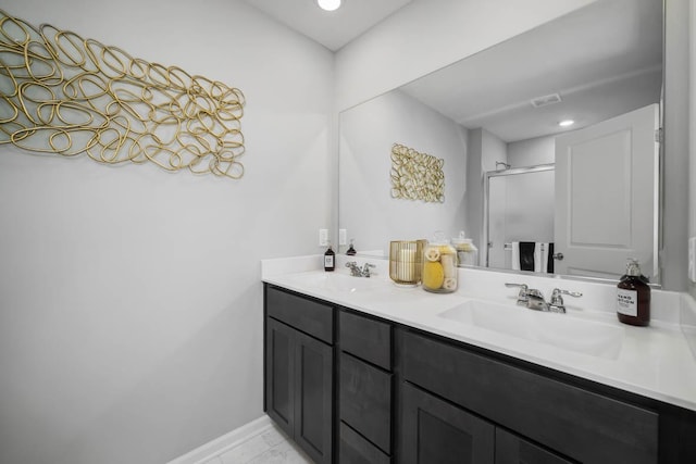 bathroom featuring vanity and a shower with door