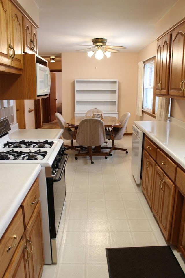 kitchen with white appliances and ceiling fan