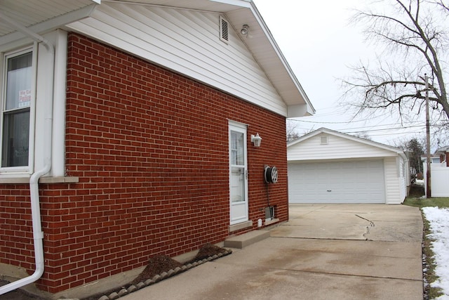 view of side of home featuring a garage and an outdoor structure