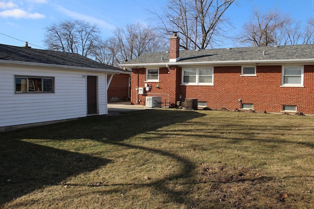 back of house with a yard and central AC unit