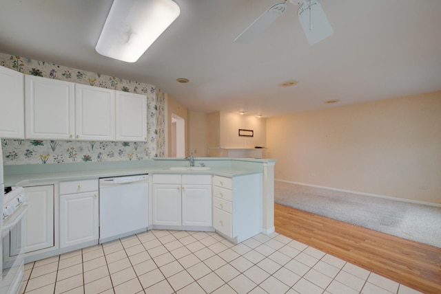 kitchen with sink, white appliances, ceiling fan, white cabinetry, and kitchen peninsula