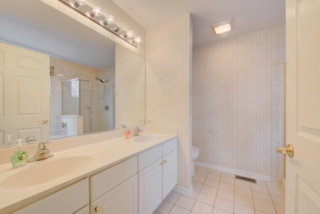 bathroom featuring an enclosed shower, vanity, tile patterned floors, and toilet