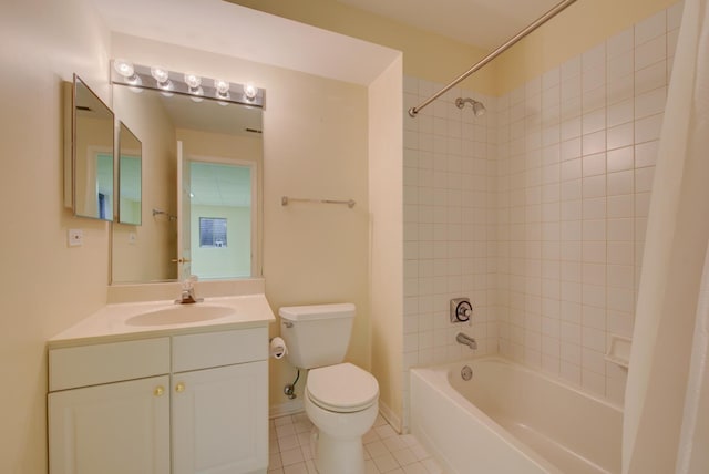 full bathroom with tiled shower / bath combo, vanity, tile patterned flooring, and toilet