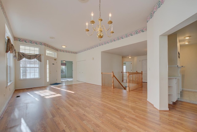 interior space with a chandelier and light wood-type flooring