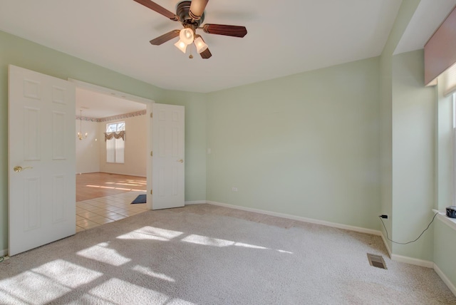 unfurnished bedroom with light carpet and ceiling fan