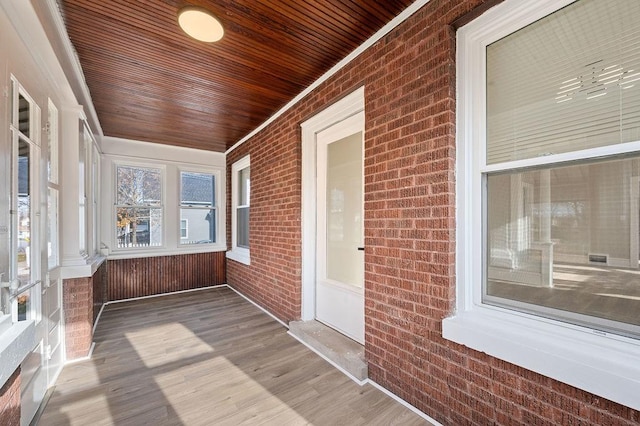 unfurnished sunroom featuring wooden ceiling