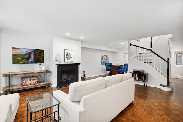 living room with dark parquet flooring and crown molding