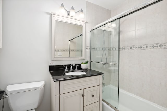 full bathroom with vanity, toilet, and enclosed tub / shower combo