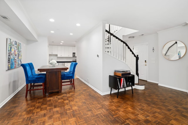 dining room with dark parquet floors and ornamental molding