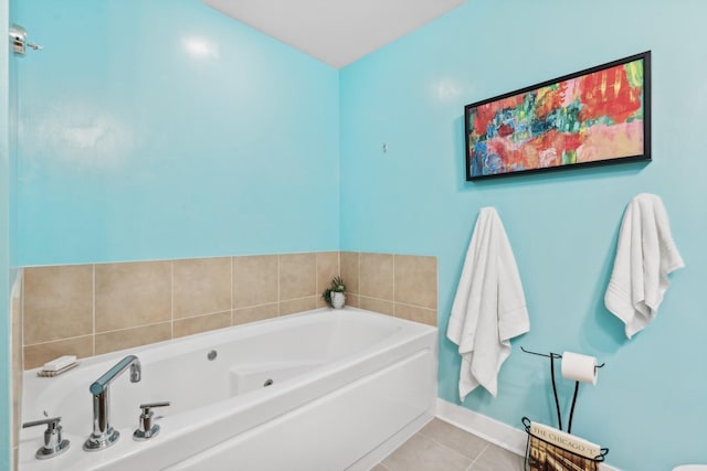 bathroom with tile patterned flooring and a bath