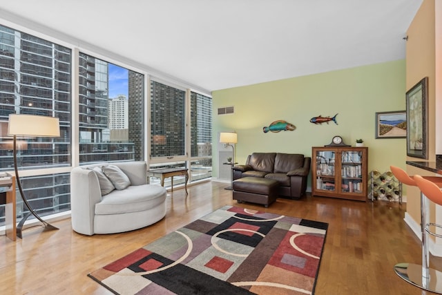 living room with hardwood / wood-style flooring and expansive windows