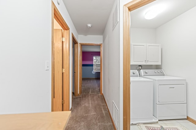 washroom featuring separate washer and dryer, carpet, and cabinets