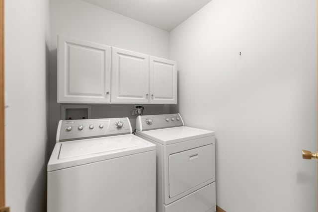 washroom featuring cabinets and independent washer and dryer