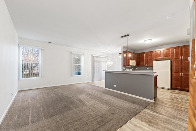 kitchen with white appliances, a center island, and hanging light fixtures