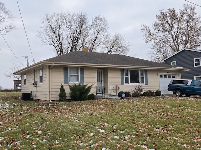 single story home with cooling unit, a garage, and a front lawn