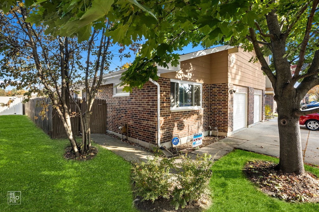 view of home's exterior with a yard and a garage