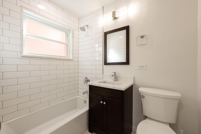 full bathroom featuring toilet, vanity, and tiled shower / bath