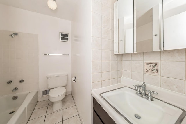 full bathroom with toilet, vanity, tiled shower / bath combo, tile patterned flooring, and backsplash