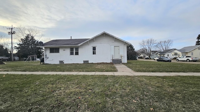 view of side of property with a lawn