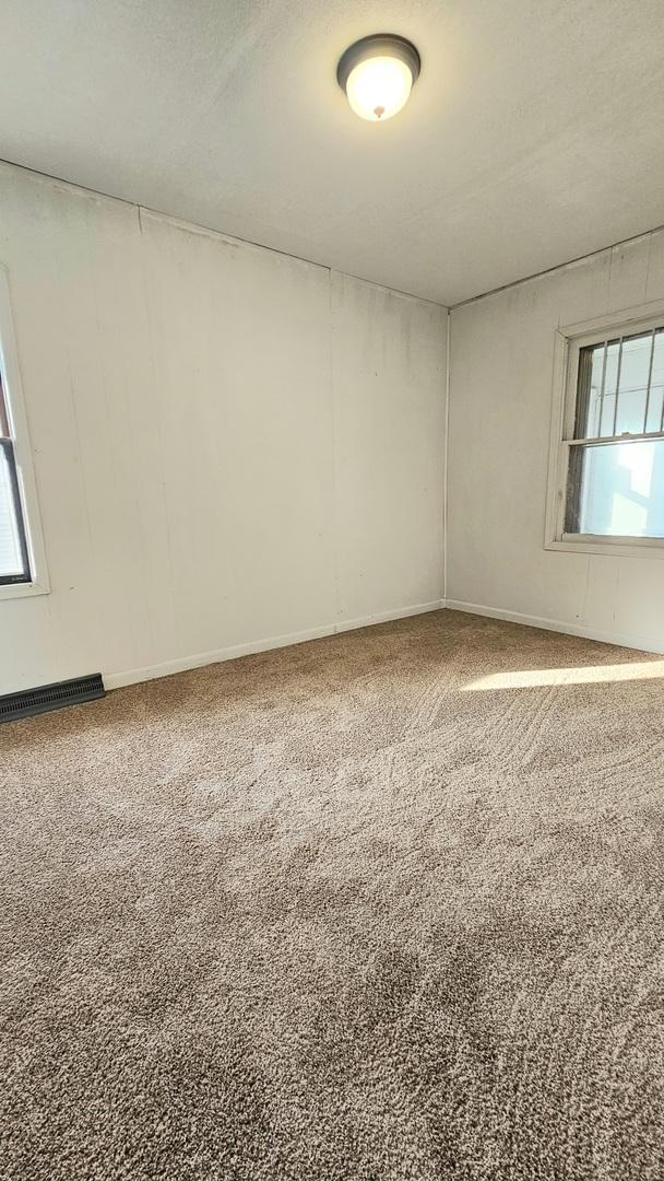 carpeted spare room featuring visible vents