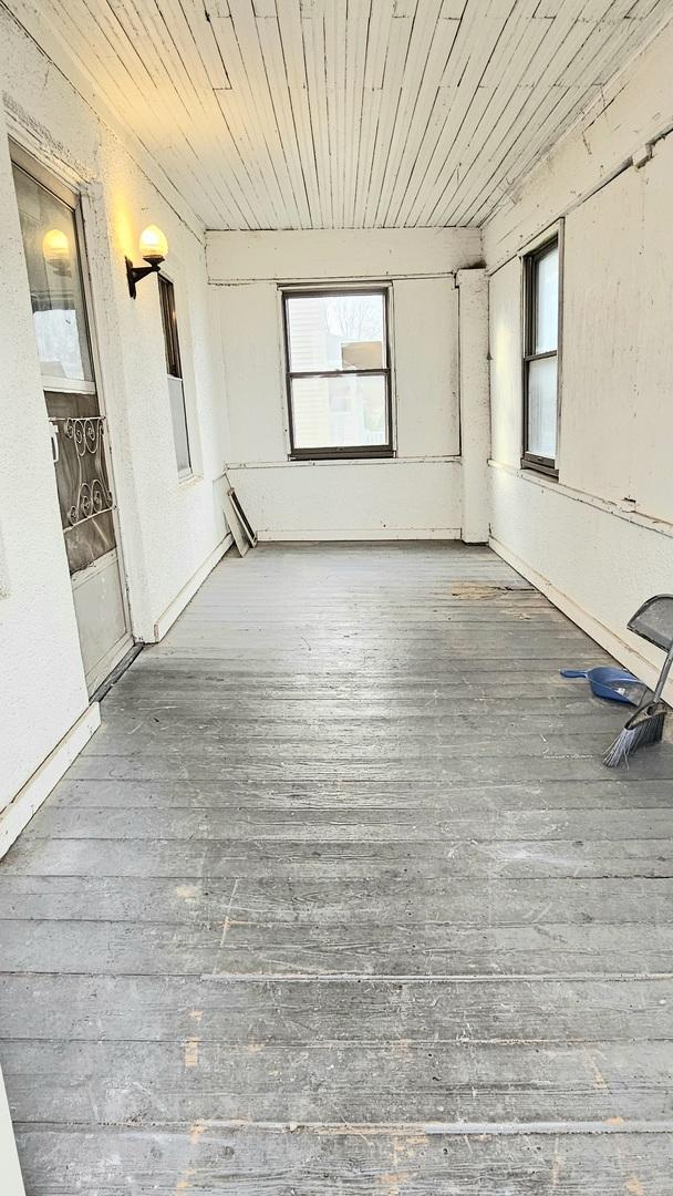 interior space with wood finished floors and wood ceiling