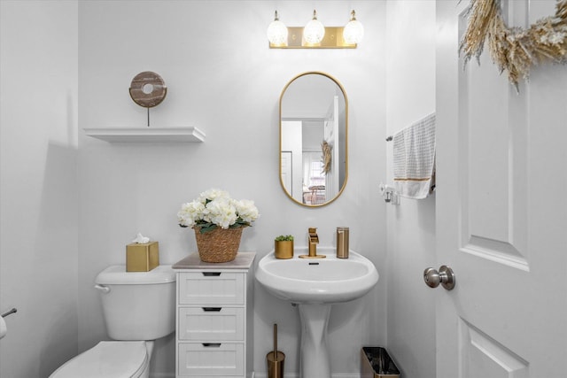 bathroom featuring toilet and sink