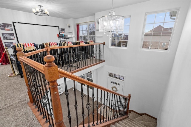 staircase with carpet and an inviting chandelier