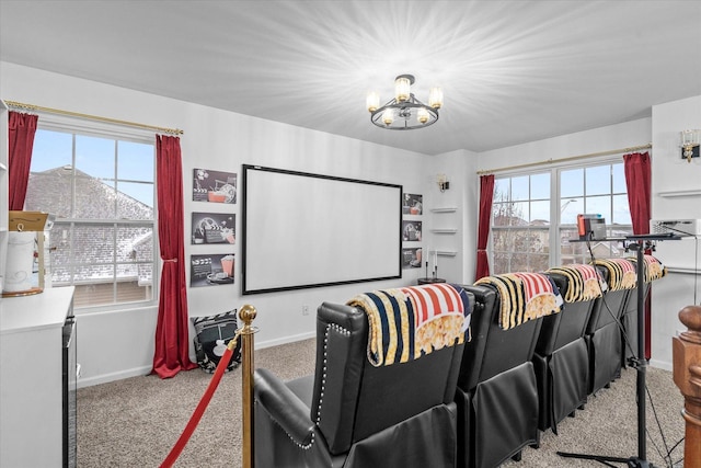 carpeted home theater with a chandelier