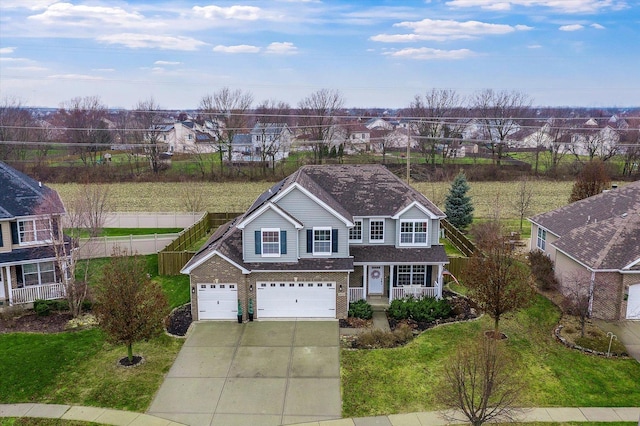 view of front of property featuring a front yard and a garage