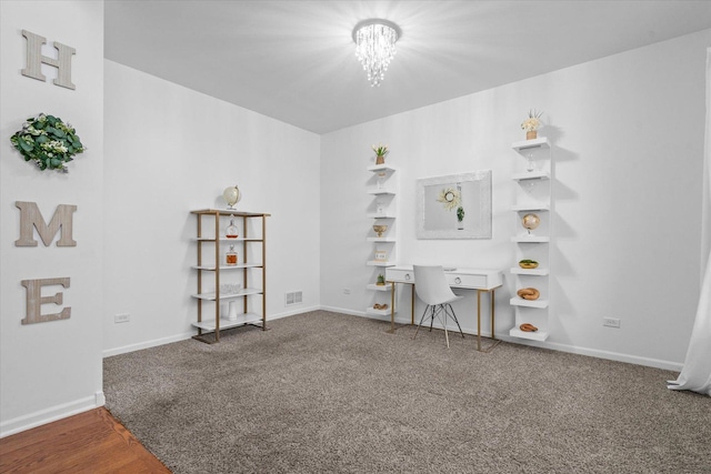 carpeted office space with a notable chandelier