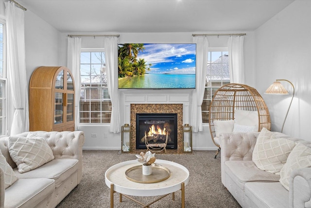 living room with carpet flooring, a wealth of natural light, and a fireplace