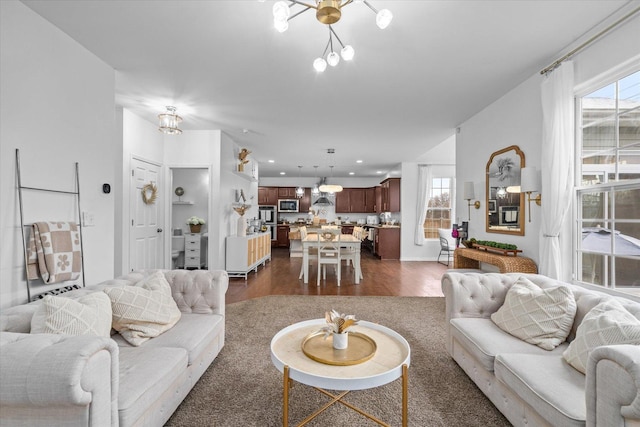 living room featuring dark hardwood / wood-style flooring and a notable chandelier