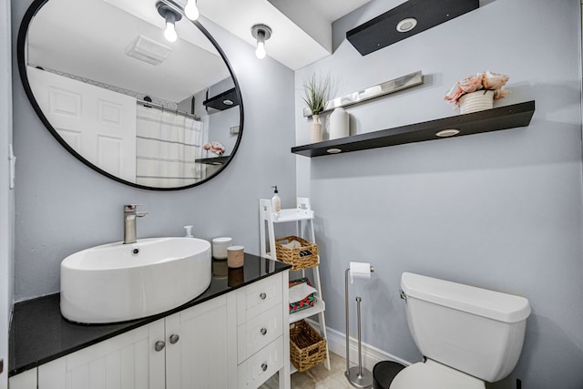 bathroom featuring walk in shower, vanity, and toilet