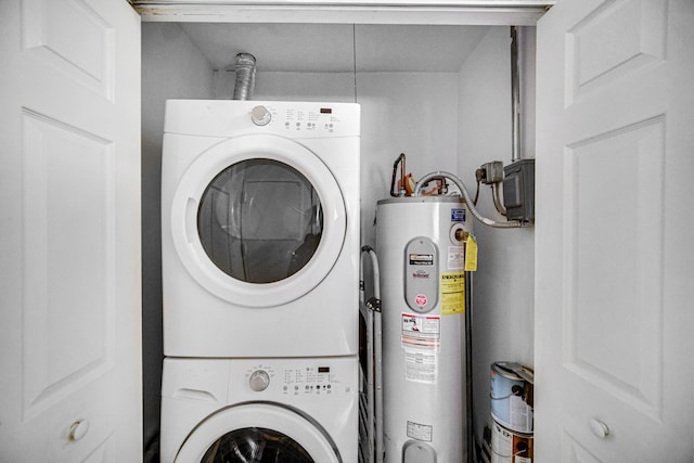 washroom featuring electric water heater and stacked washer / dryer