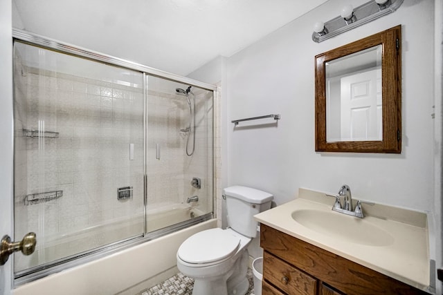 full bathroom with vanity, enclosed tub / shower combo, and toilet